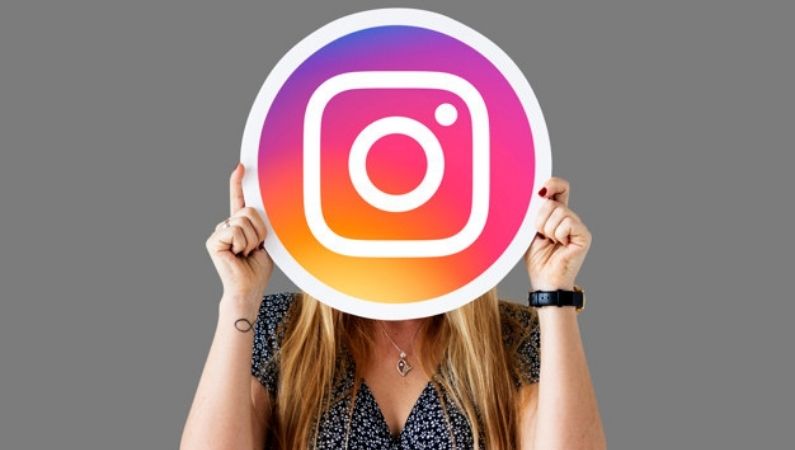woman showing instagram icon